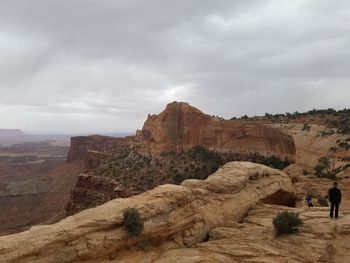 Rock formations on landscape against cloudy sky