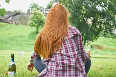 Rear view of woman with palm trees in park