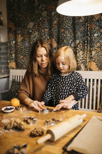 Mother and daughter making cookies