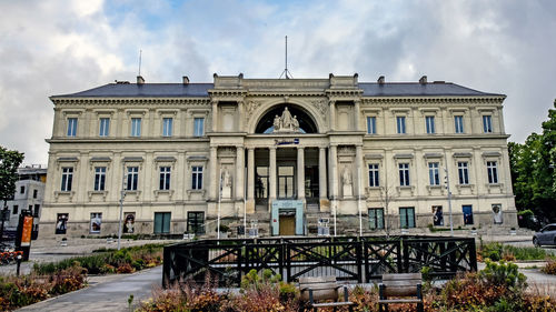 Low angle view of building against cloudy sky