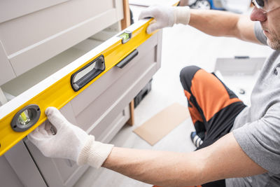 Midsection of man repairing car