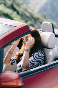 Rear view of woman sitting in car