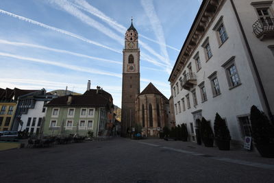 Clock tower in city against sky