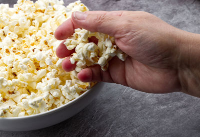 Cropped hand of person holding food
