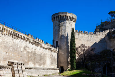 Low angle view of fort against blue sky