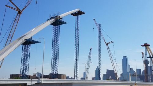 Low angle view of crane against blue sky