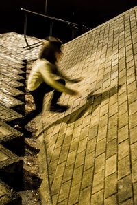 Blurred motion of man walking outdoors