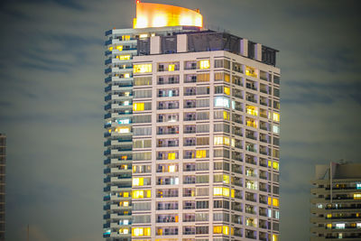 Low angle view of illuminated building against sky at dusk