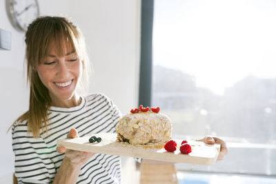 Young woman presenting vegan cake