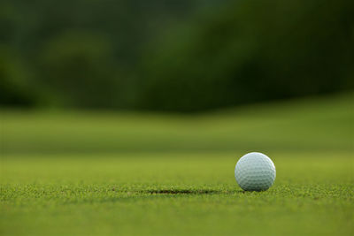 Close-up of golf ball on playing field