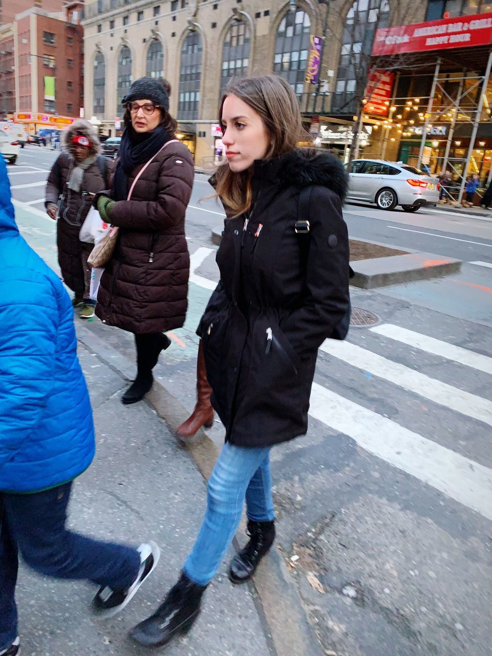 city, architecture, street, winter, full length, young adult, incidental people, people, city life, road, clothing, casual clothing, women, standing, lifestyles, adult, day, transportation, young women, warm clothing, outdoors