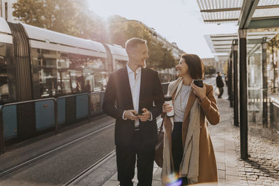 Smiling business people walking together