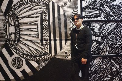 Low angle view of man standing against wall