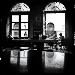 View of people sitting on wall