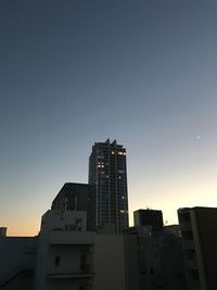 Low angle view of buildings against sky during sunset