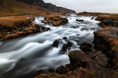 Small waterfall in iceland on a cloudy day in autumn