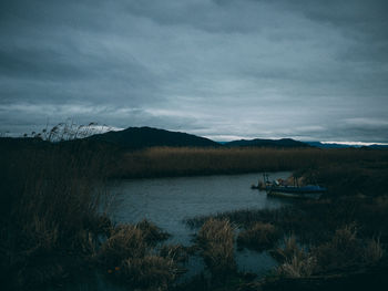 Scenic view of sea against cloudy sky