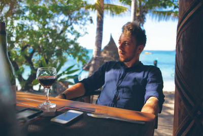 Thoughtful man sitting on chair at resort