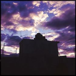 Low angle view of building against cloudy sky