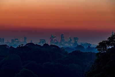 Scenic view of cityscape against sky during sunset