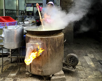 Woman cooking food in city