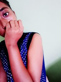 Portrait of woman against wall