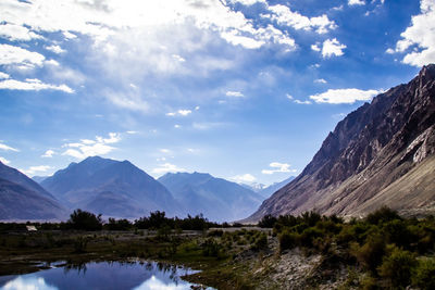 Scenic view of lake and mountains against sky