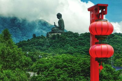 Big buddha rising above the green topped hills