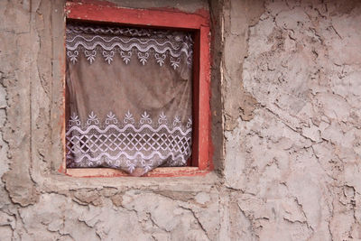 Curtain at window of old house