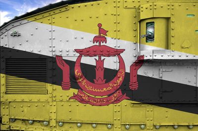 Close-up of train against yellow wall