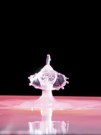 Close-up of water splashing over black background