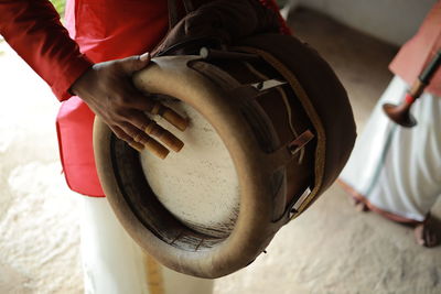 Cropped image of man holding metal