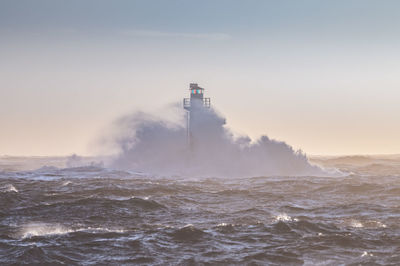 Lighthouse in stormy sea