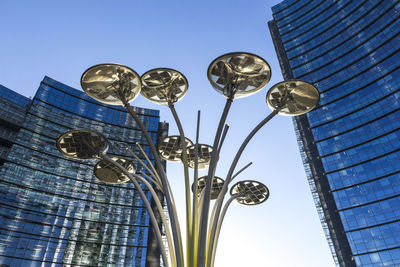 Low angle view of street light against blue sky