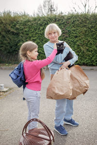 Family of ukrainian refugees, seniors and kids, fleeing from war against russia together with pet