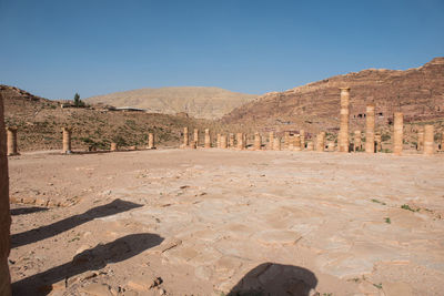 Old ruins and mountains against clear sky