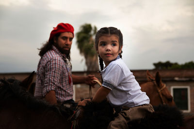 Portrait of south american father and daughter wearing traditional clothing