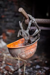 Close-up of abandoned hardhat hanging outdoors