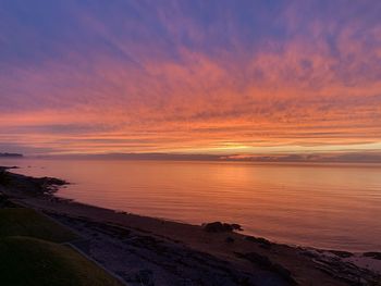 Scenic view of sea against romantic sky at sunset