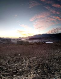 Scenic view of desert against sky during sunset