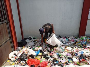 Waste management officers are sorting plastic waste before it is processed into fuel oil