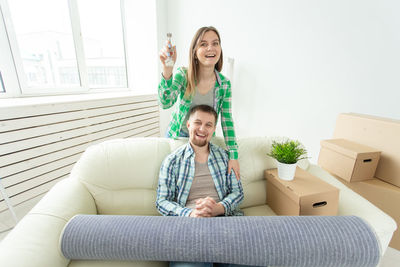 Young couple sitting on sofa at home