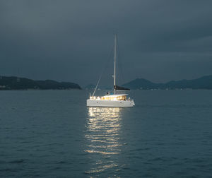 Sailboat sailing on sea against sky