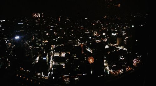 Aerial view of illuminated buildings in city at night