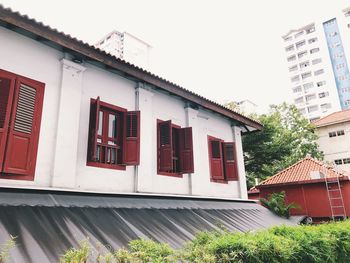 Exterior of house by building against sky