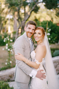 Portrait of smiling couple standing outdoors