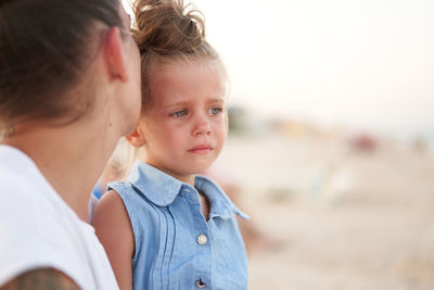 Close-up of mother and son outdoors