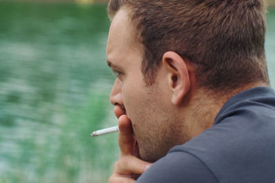 Portrait of man smoking cigarette