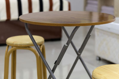 Close-up of empty chairs on table