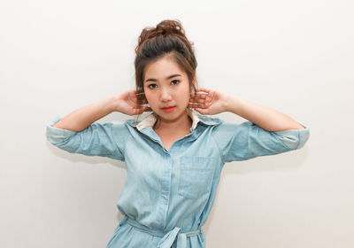 Portrait of beautiful young woman over white background